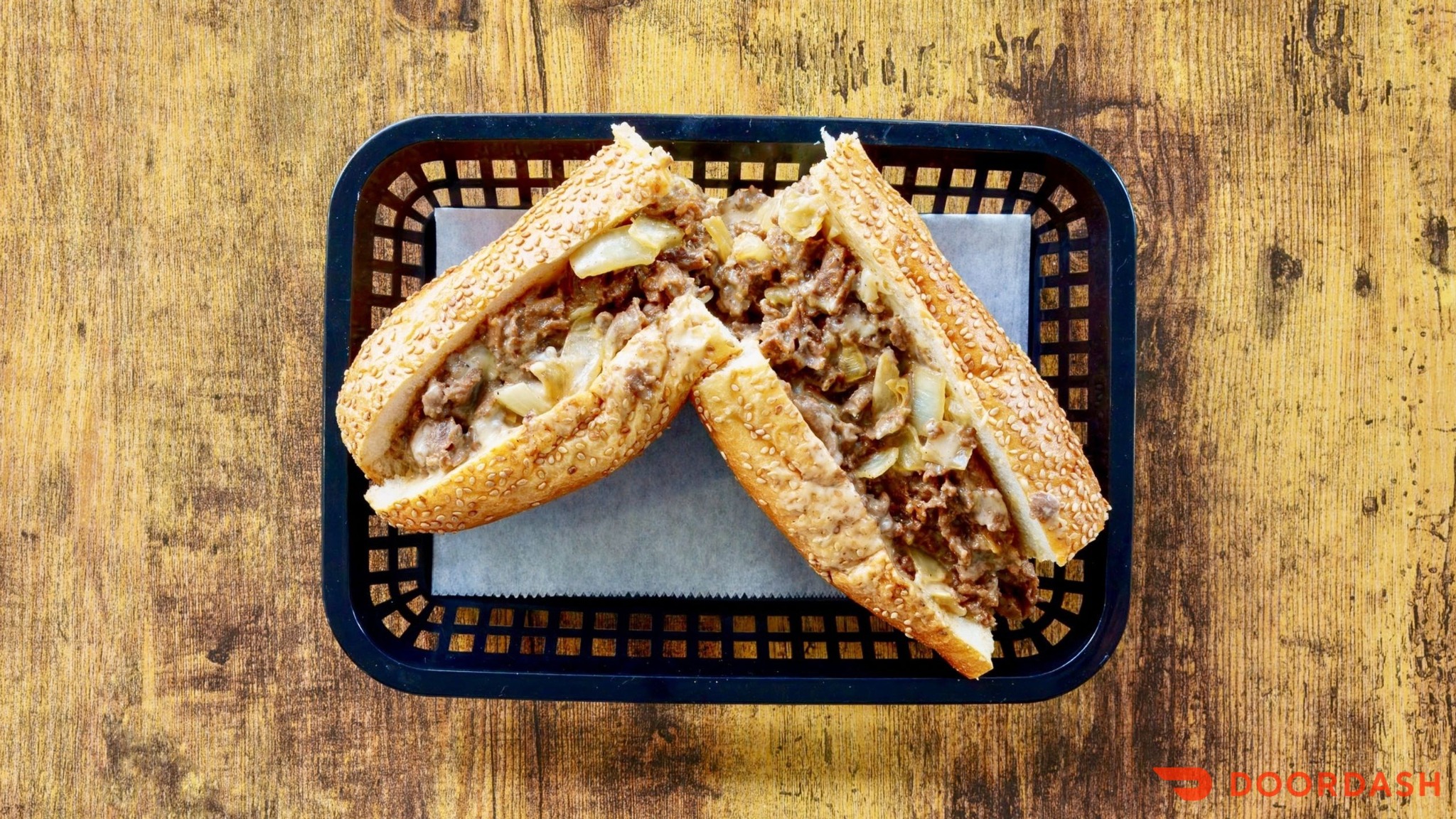 Our cheesesteak with melted cheese on a seeded roll